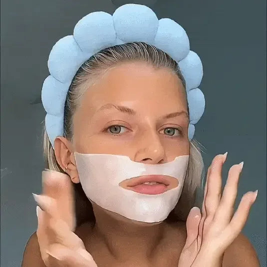 Woman with blue padded headband applying Lakerain® Bio-Collagen Deep Hydration hydrogel mask under chin against grey background